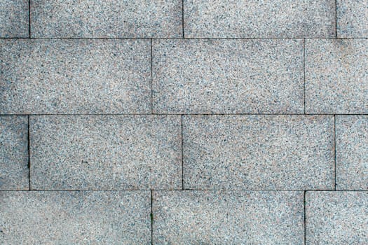 road paved with sidewalk tiles. beautiful brick background with, masonry texture of light gray bricks. outdoor closeup