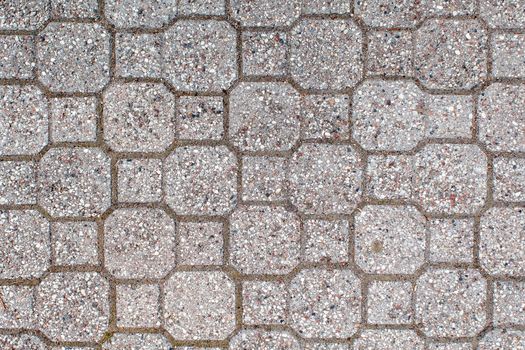 road paved with sidewalk tiles. beautiful brick background with, masonry texture of light gray bricks. outdoor closeup