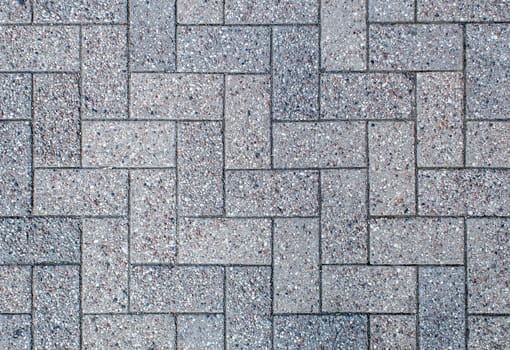 road paved with sidewalk tiles. beautiful brick background with, masonry texture of light gray bricks. outdoor closeup