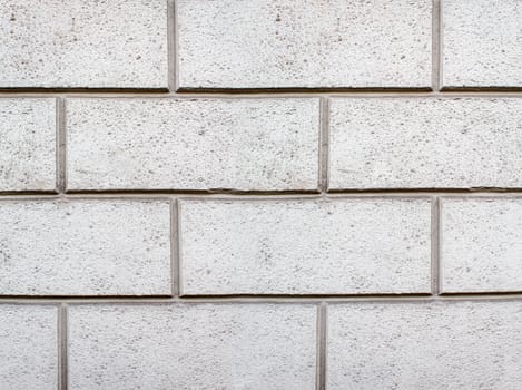 road paved with sidewalk tiles. beautiful brick background with, masonry texture of light gray bricks. outdoor closeup