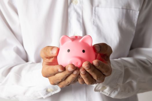 Hand of kid holding coin put in piggy bank with money stack growing growth saving money, Concept invesment for financial freedom plan, business deposit to hope success