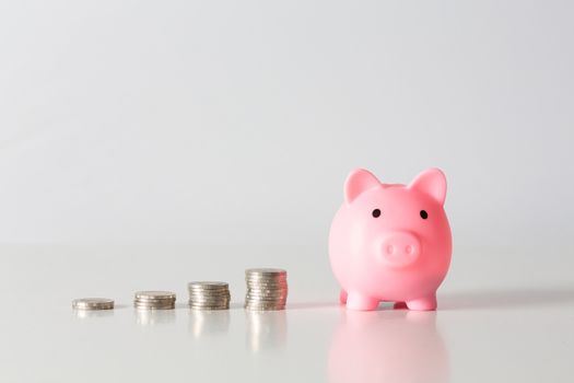 Hand of kid holding coin put in piggy bank with money stack growing growth saving money, Concept invesment for financial freedom plan, business deposit to hope success