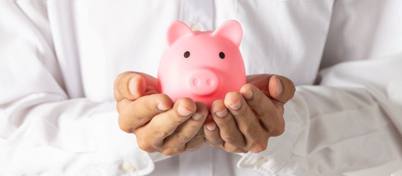 Hand of kid holding coin put in piggy bank with money stack growing growth saving money, Concept invesment for financial freedom plan, business deposit to hope success