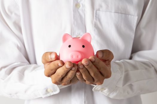 Hand of kid holding coin put in piggy bank with money stack growing growth saving money, Concept invesment for financial freedom plan, business deposit to hope success