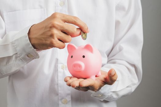 Hand of kid holding coin put in piggy bank with money stack growing growth saving money, Concept invesment for financial freedom plan, business deposit to hope success