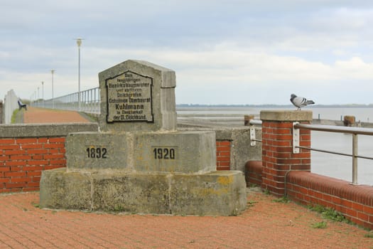 Monument Kapitän Hullman and dike on the north German coast of Butjardingen in Lower Saxony, Germany.