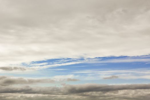 Blue streak in the cloudy sky. Sky panorama in Lower Saxony, Germany.