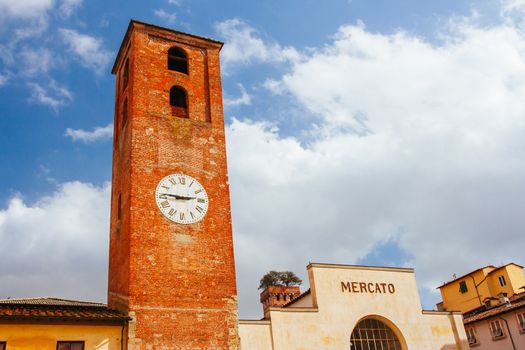 Lucca, Italy - March 3rd 2008: Beautiful historic architecture of Mercato del Carmine and church of Santa Maria del Carmine in Lucca Italy on a cool winter's evening