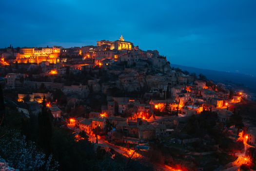 The sun descends at dusk on a winter's day in Gordes, Provence, France