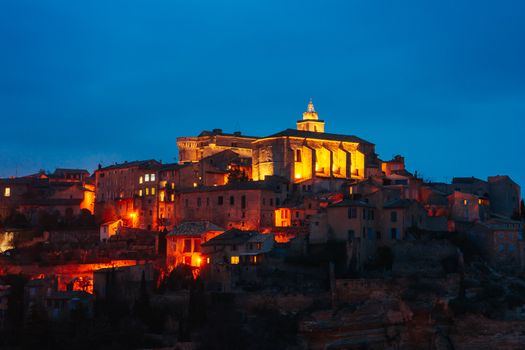 The sun descends at dusk on a winter's day in Gordes, Provence, France