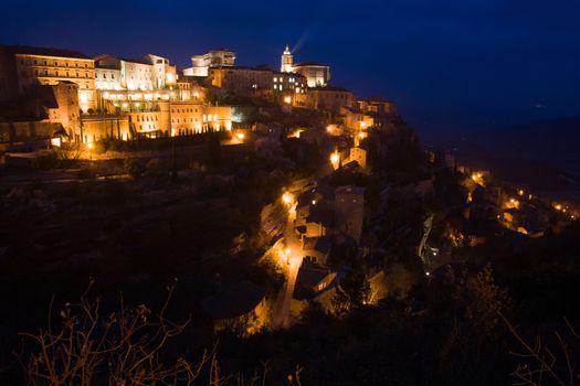 The sun descends at dusk on a winter's day in Gordes, Provence, France