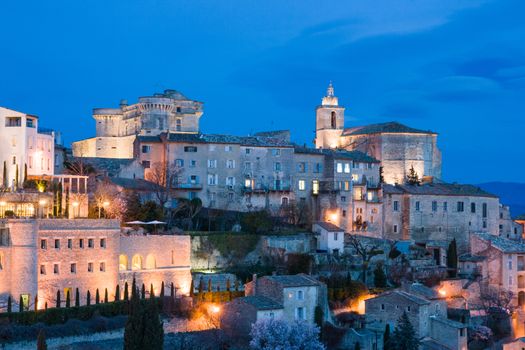 The sun descends at dusk on a winter's day in Gordes, Provence, France