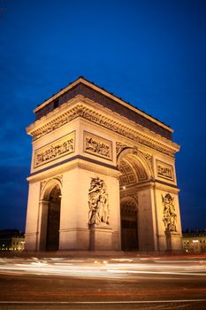 Rush hour traffic drives around the Arc de Triomphe in Paris, France