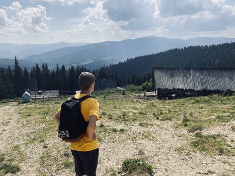 man in the mountains near the house