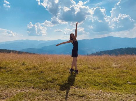 happy young woman jumping on the meadow