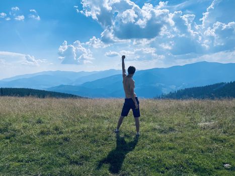 happy young man with arms raised