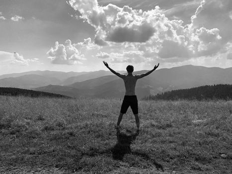 happy young man with arms raised