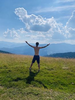 happy young man with arms raised