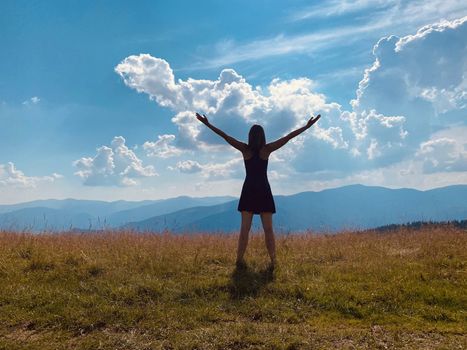 happy young woman jumping on the meadow