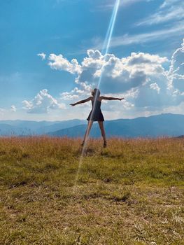 happy young woman jumping on the meadow
