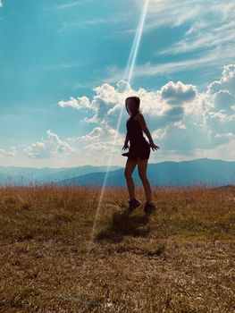 happy young woman jumping on the meadow