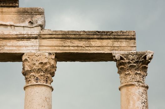 Apamea, Syria - May, 2009: Syria before the war. the Great Colonnade and triumphal arches in the impressive Apamea Greek and Roman city of Apamea in Syria. . Column tops the Corinthian order is the most ornate of the Greek orders, column having an ornate capital decorated with two rows of acanthus leaves.The site includes the famous Great Colonnade, one of the longest in the world. Because civil war in Syria that started in 2011 the Apamea ruins have been damaged and looted by treasure hunters.