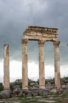 Apamea, Syria - May, 2009: Syria before the war. the Great Colonnade and triumphal arches in the impressive Apamea Greek and Roman city of Apamea in Syria. Apamea was an ancient Greek and Roman city on the banks of the Orontes River in Syria. The site includes the famous Great Colonnade, one of the longest in the world. As a result of the ongoing civil war in Syria that started in 2011, the Apamea ruins have been damaged and looted by treasure hunters.