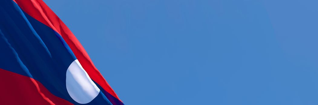 3D rendering of the national flag of Laos waving in the wind against a blue sky