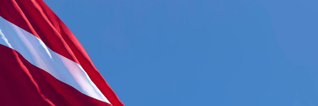 3D rendering of the national flag of Latvia waving in the wind against a blue sky