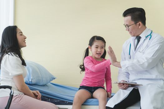 Asian adult mother and childhood daughter consult a professional doctor at the clinic. Pediatrician medical checkup Child patient And inquiring about the health. Medical advice consultation concept