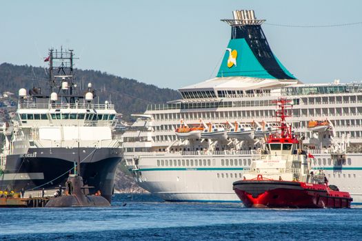 Bergen, Norway, May 2015: Harbor scene in Bergen, Norway, with cruise ship and towing boat and submarine