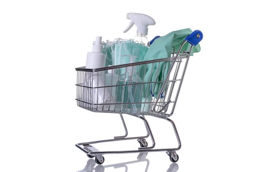 Shopping cart filled with different kinds of desinfectants on white background.