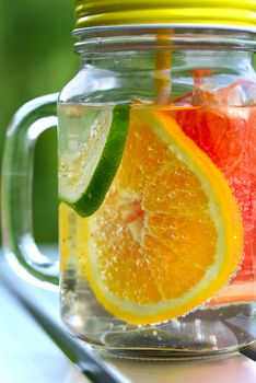 Detox water with fruit. Orange, lemon, lime, grapefruit