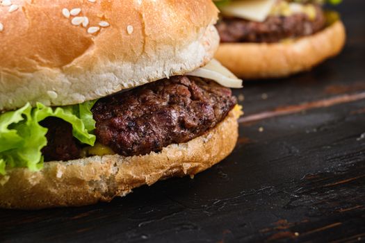 Fresh tasty burger on wooden table.