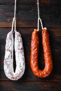 Smoked sausages meat hanging on wooden background.