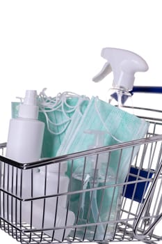 Shopping cart filled with different kinds of desinfectants on white background.