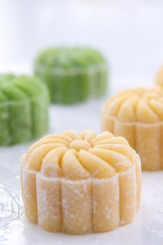 Young woman is making colorful snow skin moon cake, recipe of sweet snowy mooncake, traditional savory dessert for Mid-Autumn Festival, close up, lifestyle.