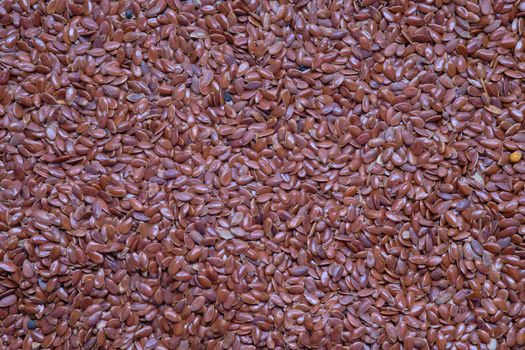 Close up of flax seeds as background, top view.