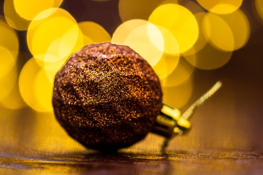 Colorful Christmas ball isolated on blurred and shiny background of lights. Christmas baubles isolated.