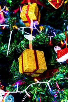 Christmas hanging decorations on fir tree. Decorated Christmas tree. Fir branch with Christmas baubles decorations.