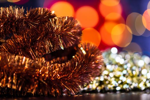 Decorations and ornaments in a colorful Christmas composition isolated on background of blurred lights.