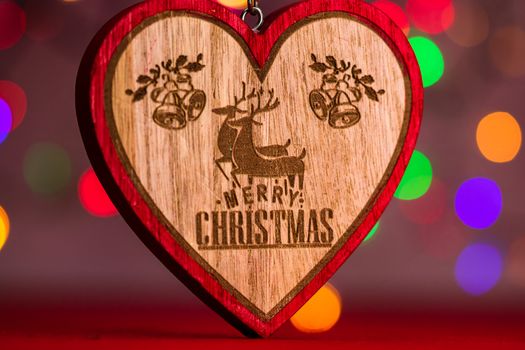 Heart shaped Christmas decoration isolated on blurred background of lights.