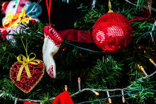 Christmas hanging decorations on fir tree. Decorated Christmas tree. Fir branch with Christmas baubles decorations.