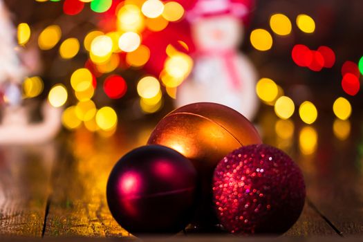 Decorations and ornaments in a colorful Christmas composition isolated on background of blurred lights.