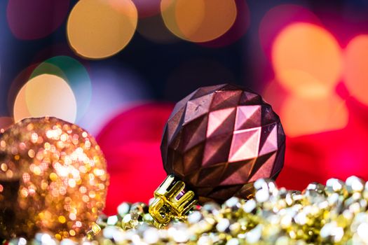 Decorations and ornaments in a colorful Christmas composition isolated on background of blurred lights.