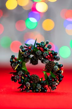 Colorful decorated Christmas wreaths isolated on background of blurred lights.