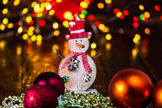 Decorations and ornaments in a colorful Christmas composition isolated on background of blurred lights.