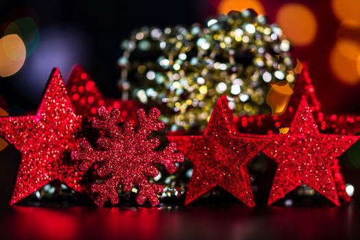 Decorations and ornaments in a colorful Christmas composition isolated on background of blurred lights.