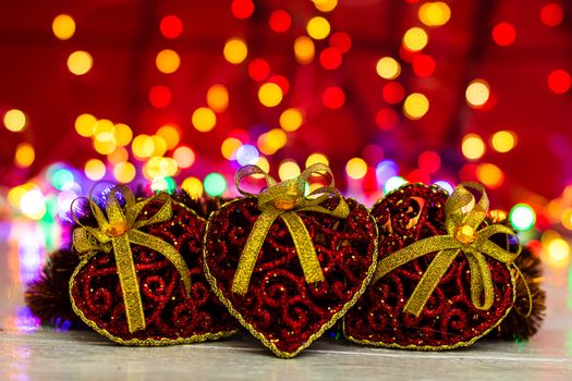 Decorations and ornaments in a colorful Christmas composition isolated on background of blurred lights.