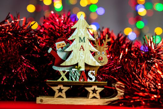 Decorations and ornaments in a colorful Christmas composition isolated on background of blurred lights.